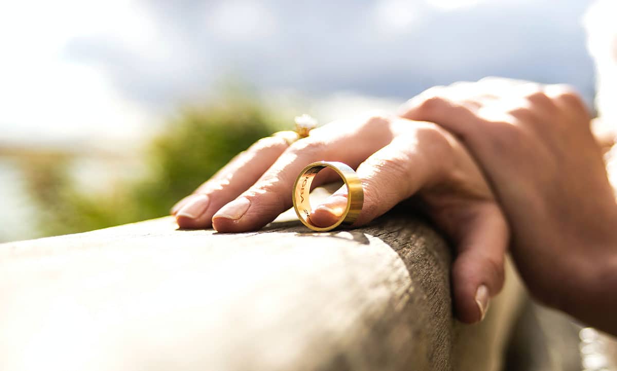Closeup of hands holding a ring.