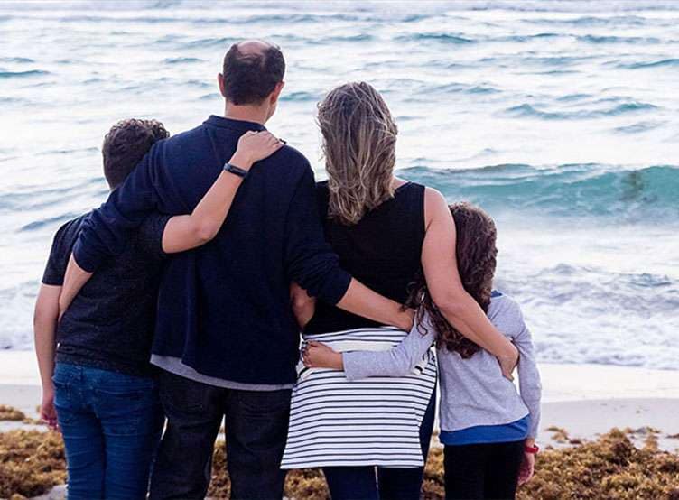 Family at the beach looking out to sea